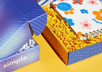 Open custom mailer box with kraft crinkle paper and branded interior