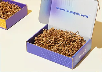 Open custom mailer boxes with printed interiors and decorative crinkle paper