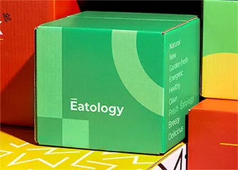 Custom green Eatology shipping box open with plant inside