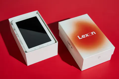 Custom rigid box with a tablet in its base and the printed lift-off lid beside it