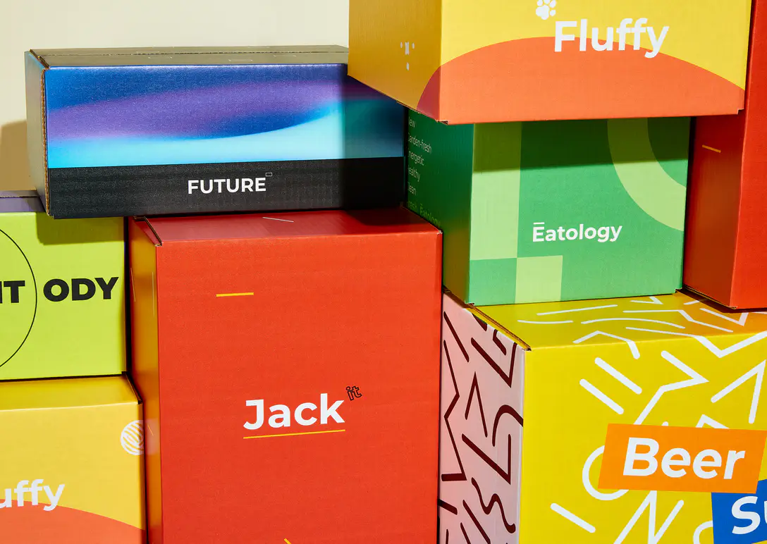 A stack of custom printed shipping boxes in bright brand colors