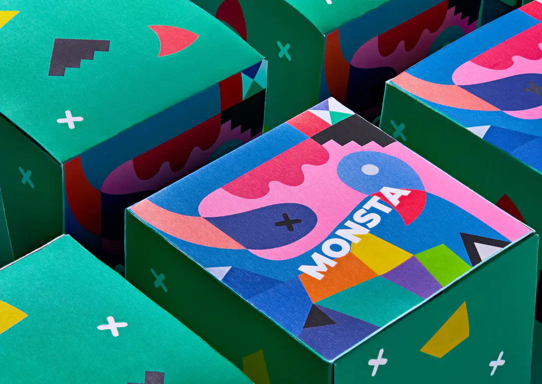 Custom folding boxes with a bold illustrated print, stacked on a green background
