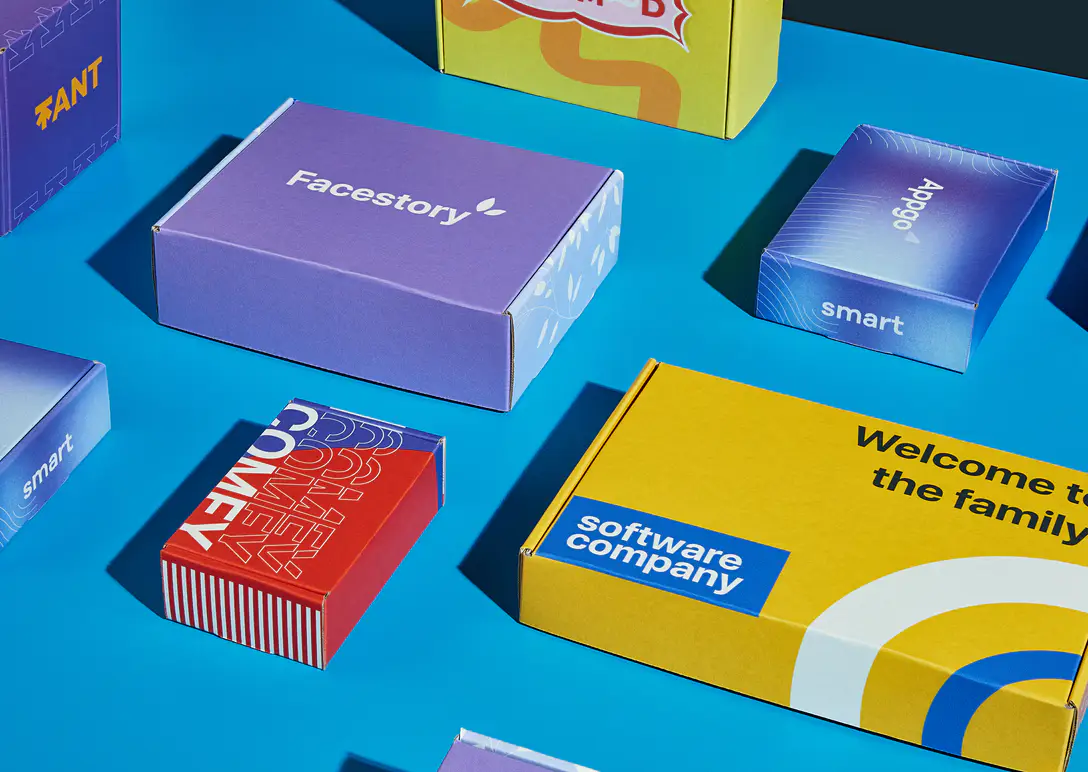 Custom printed mailer boxes in several colors and sizes laid out on a blue background